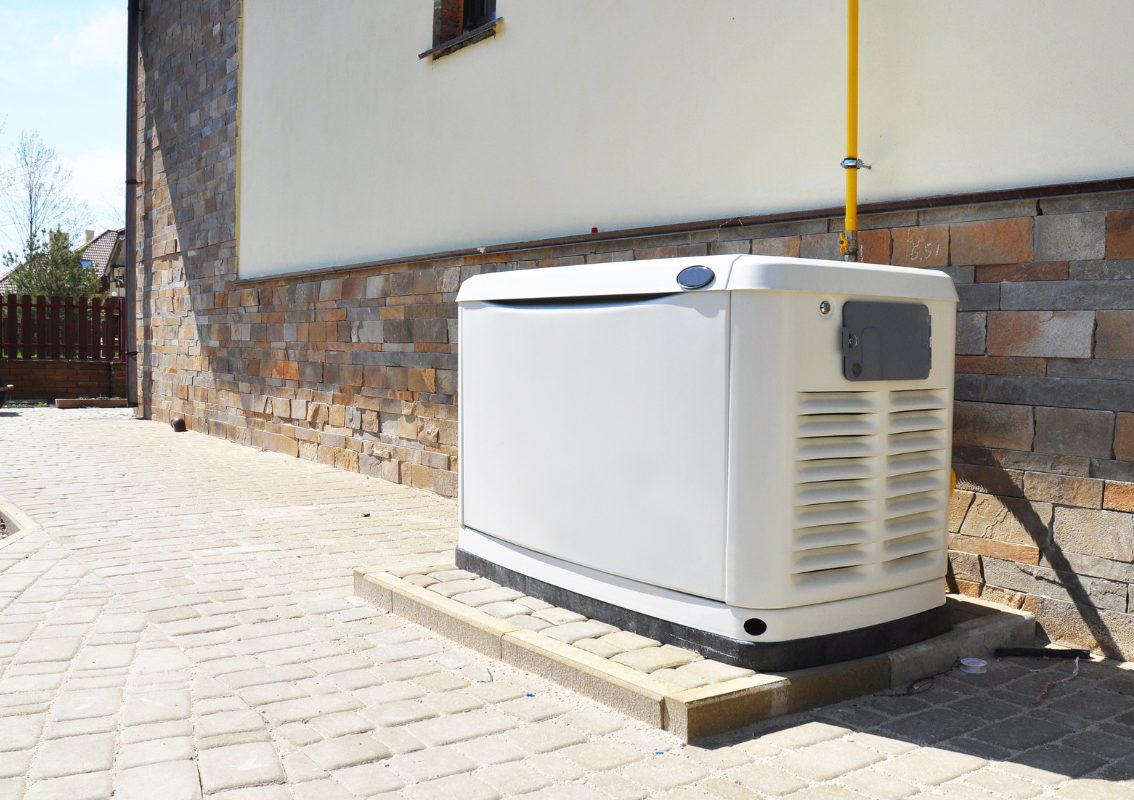 Home standby backup generator beside a Durham residence