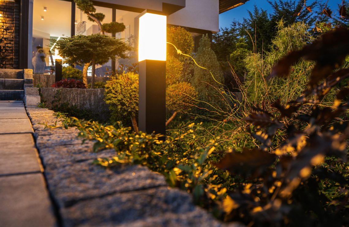 Residential landscape lighting at dusk in Durham